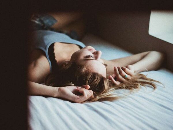 woman lying on bed inside room screengrab