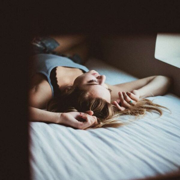 woman lying on bed inside room screengrab