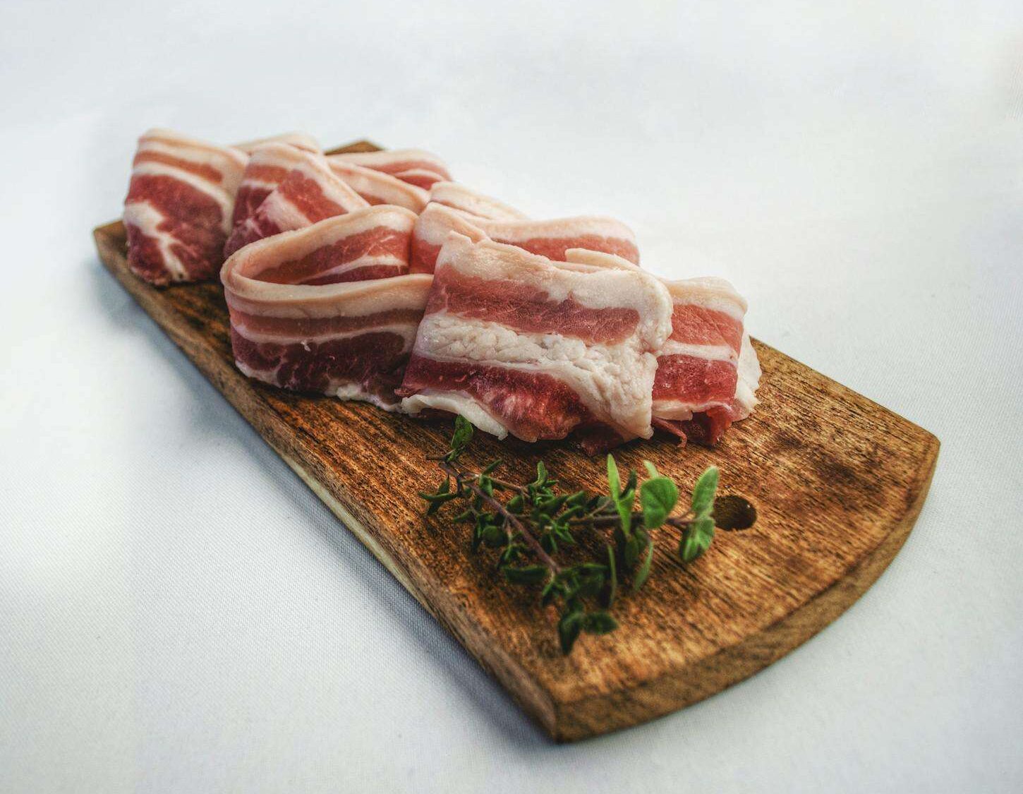 Food Photography of Sliced Bacon on Top of Brown Chopping Board