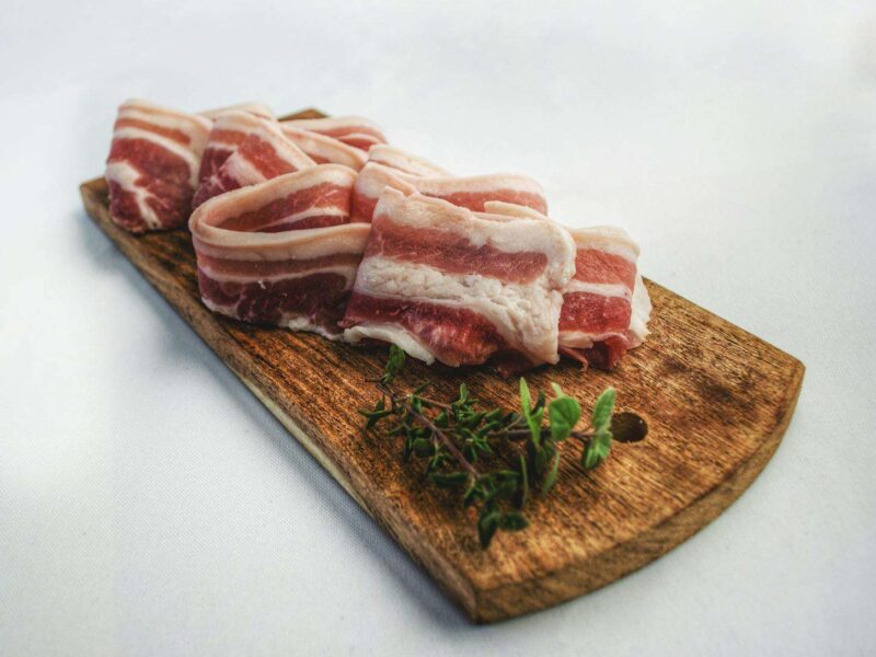 Food Photography of Sliced Bacon on Top of Brown Chopping Board